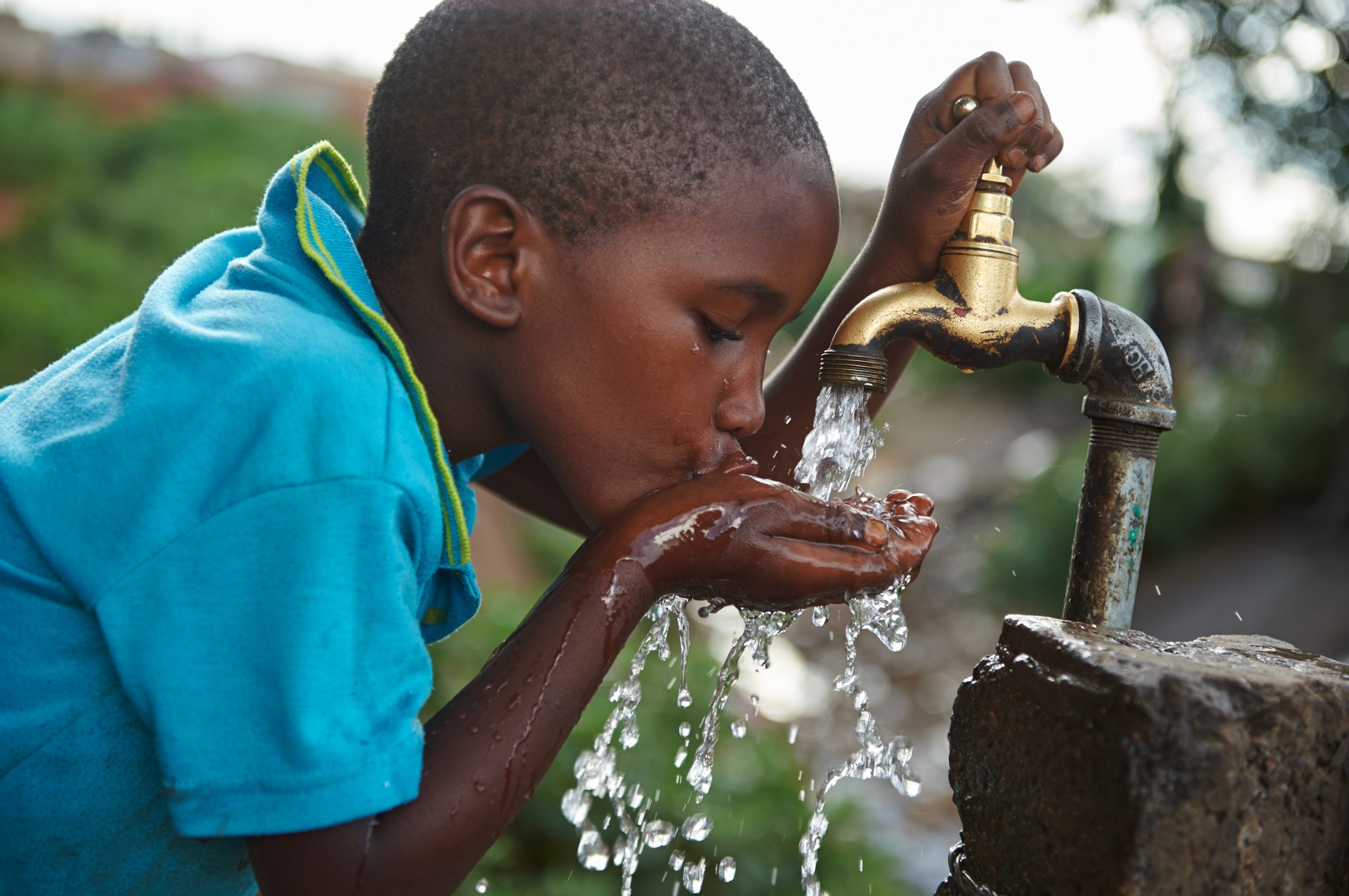 Child drinking clean water from a tap
