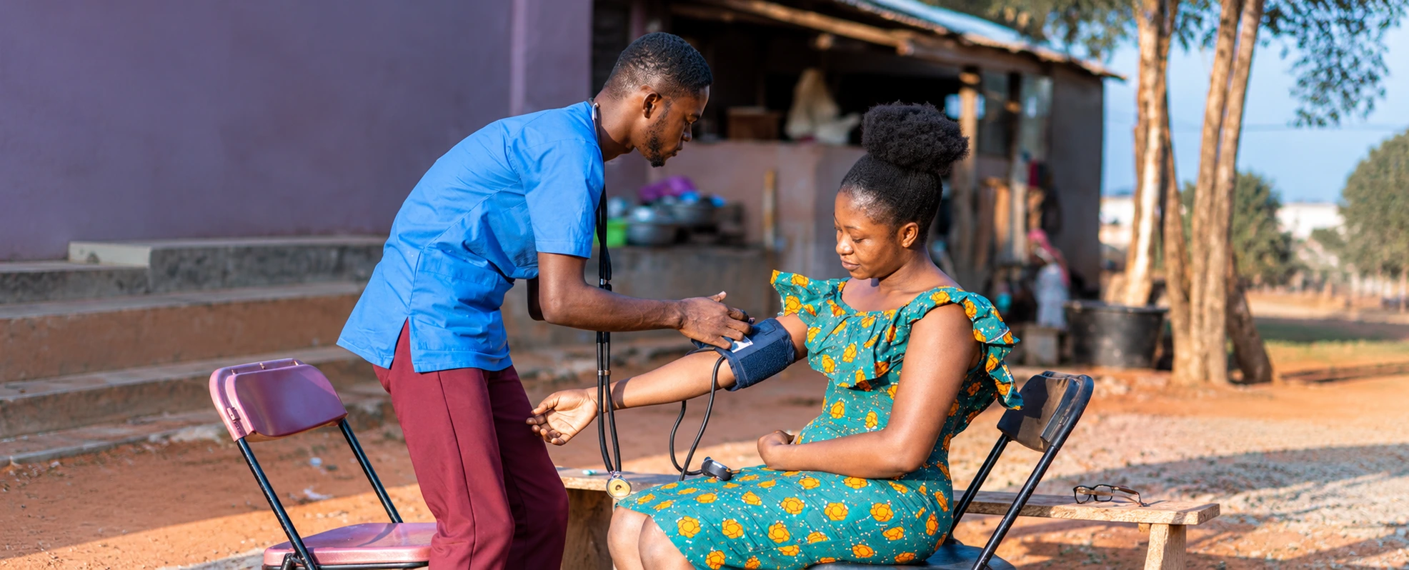 A health worker checking blood pressure in a community setting