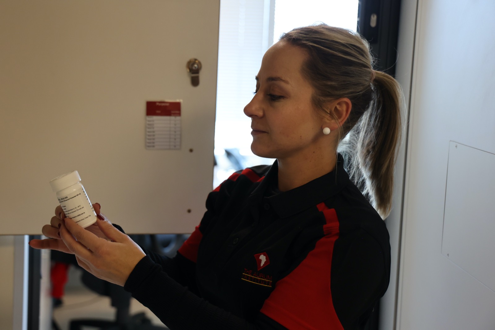 An Aurum staff member checking labelled research medication