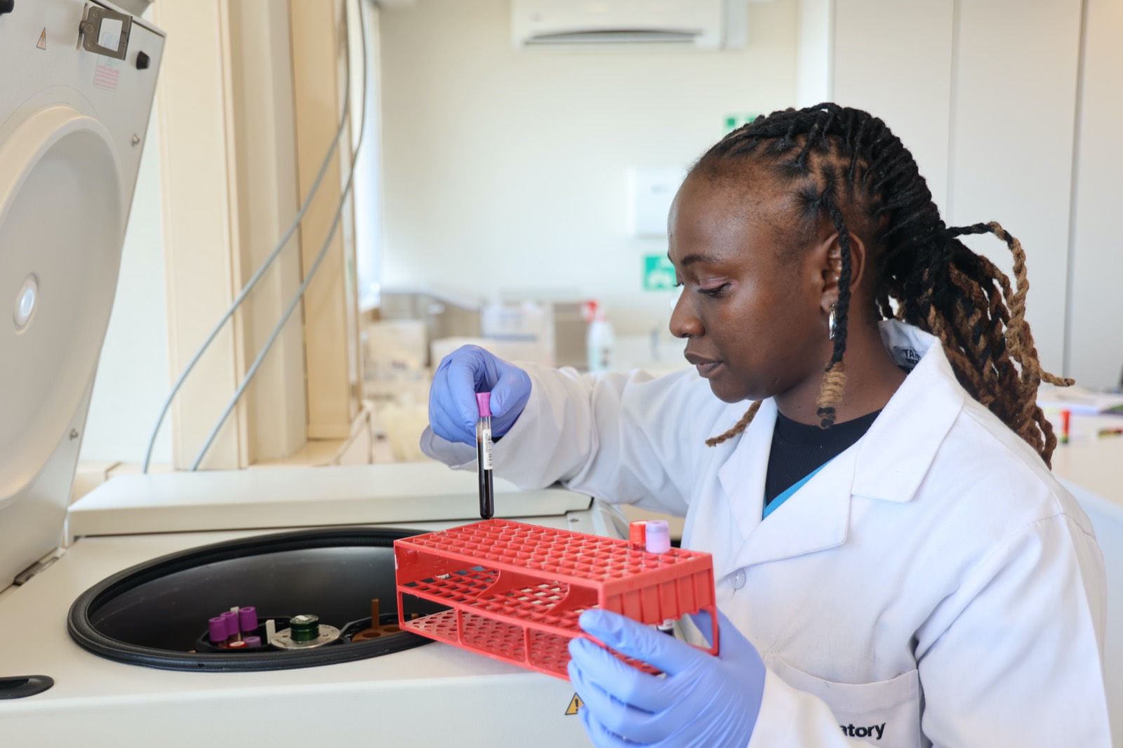 An Aurum laboratory technician processing patient samples